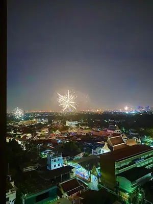 a city with a firework in the sky at night at New 1-Bedroom Condo for Rent 0 Meters from BTS Wutthakat in Bang Khun Thian