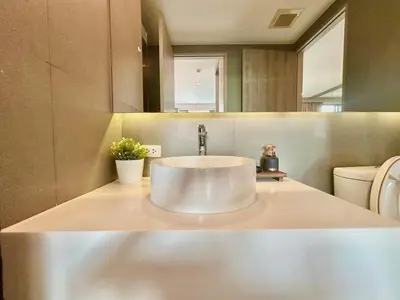 a bathroom with a sink and a toilet at Luxury & Bright 1 Bedroom - Asoke in Bangkok