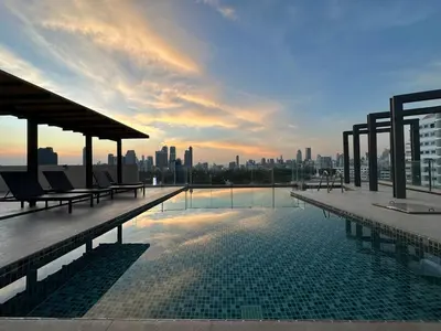 a rooftop swimming pool with a view of the city at Luxury & Bright 1 Bedroom - Asoke in Bangkok