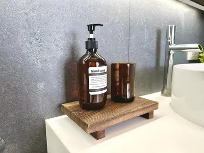 a bottle of soap sitting on a bathroom sink at Bright & Spacious 1 BR - ASOKE in Bangkok