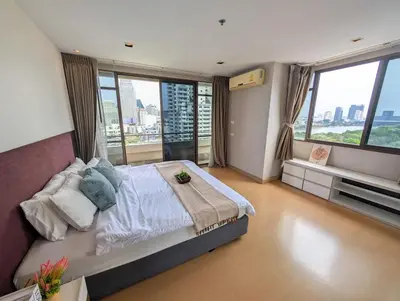 a bedroom with a large bed and large windows at High Floor Great View 2BR 2BA 3 mins to Nana BTS in Bangkok