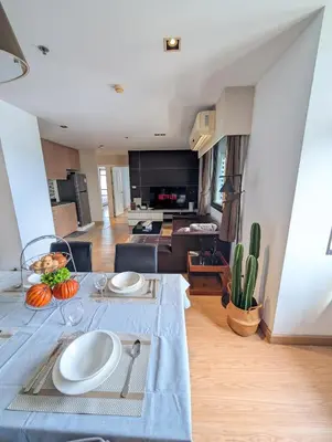 a living room with a table with plates on it at High Floor Great View 2BR 2BA 3 mins to Nana BTS in Bangkok