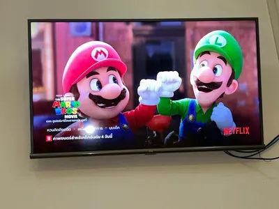 a television with two mario characters on the screen at 731 Hostel Victory Monument in Sathani Sam Sen