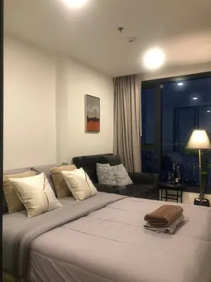 a bedroom with a large bed and a couch at Luxury condo in Bangkok,NearBTSMochit,MRTChatuchak in Bangkok