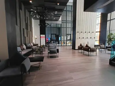 a lobby with couches and chairs in a building at Luxury condo in Bangkok,NearBTSMochit,MRTChatuchak in Bangkok