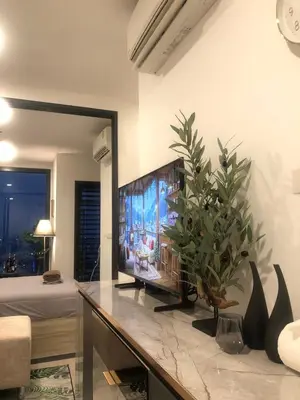 a living room with a tv on a table at Luxury condo in Bangkok,NearBTSMochit,MRTChatuchak in Bangkok