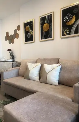 a living room with a couch and some pictures on the wall at Luxury condo in Bangkok,NearBTSMochit,MRTChatuchak in Bangkok