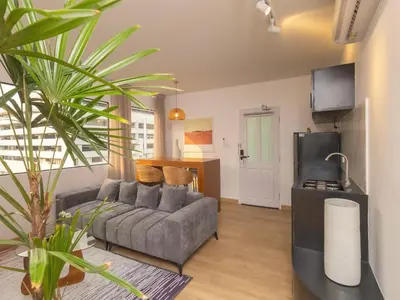 a living room with a couch and a kitchen at 2 Bedrooms for 3 guest comfy home at heart of Silom - 7A in Bangkok