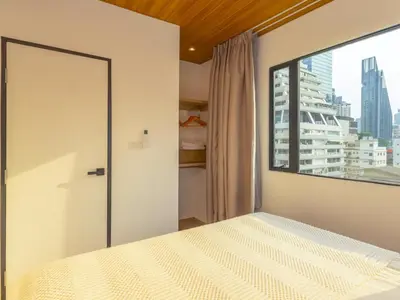 a bedroom with a bed and a large window at 2 Bedrooms for 3 guest comfy home at heart of Silom - 7A in Bangkok