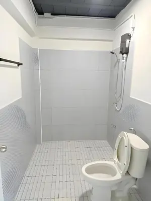 a white bathroom with a toilet and a shower at XX Yellow Place Sukhumvit Soi 2 - BTS Nana in Bangkok