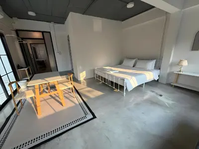 a bedroom with a bed and a table in it at XX Yellow Place Sukhumvit Soi 2 - BTS Nana in Bangkok