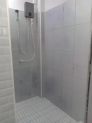 a bathroom with a shower with a glass door at XX Yellow Place Sukhumvit Soi 2 - BTS Nana in Bangkok