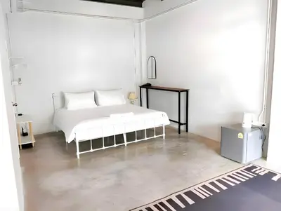 a white bedroom with a white bed in it at XX Yellow Place Sukhumvit Soi 2 - BTS Nana in Bangkok