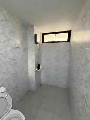 a bathroom with a toilet and a window at XX Yellow Place Sukhumvit Soi 2 - BTS Nana in Bangkok