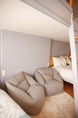 a living room with a couch and a bed at Spacious Relaxing Townhouse with Rooftop in Ekamai in Bangkok