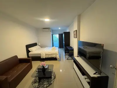 a small living room with a bed and a couch at Natthapimon in Bangkok Yai