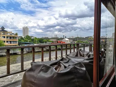 a balcony with a view of a river at Siamotif Boutique Hotel in Bangkok