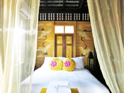 a bed with two colorful pillows on top of it at Siamotif Boutique Hotel in Bangkok
