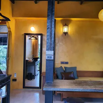 a living room with a table and a fireplace at Siamotif Boutique Hotel in Bangkok