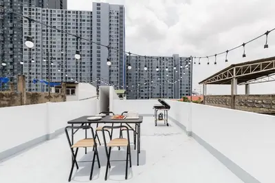 a table and chairs on the roof of a building at 72 House & Cafe in Phra Khanong