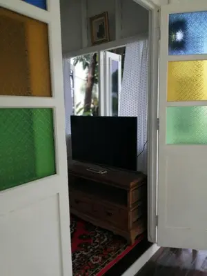 a door with a television in a room at Baan Chay Klong, Canal side Classic Home 2BRs in Ban Bang Toei (1)