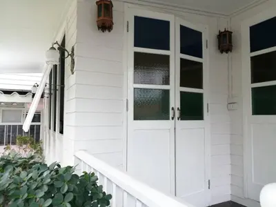 a white house with a white door and windows at Baan Chay Klong, Canal side Classic Home 2BRs in Ban Bang Toei (1)