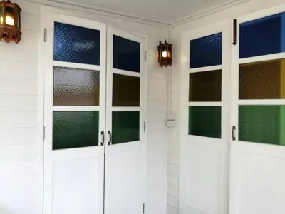 a room with white doors and windows on a wall at Baan Chay Klong, Canal side Classic Home 2BRs in Ban Bang Toei (1)