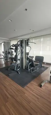 a gym with several treadmills and chairs in a room at Executive 2 Bed Nana BTS 100m Bangkok Skyline in Bangkok