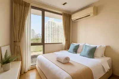 a bedroom with a large bed with a large window at City Center Nana 4-Guest Suite 100m Nana BTS in Bangkok