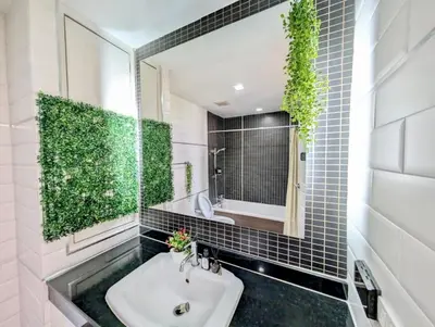 a bathroom with a sink and a mirror at City Center Nana 4-Guest Suite 100m Nana BTS in Bangkok