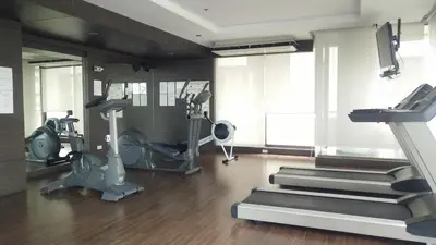 a gym with treadmills and ellipticals in a room at City Center Nana 4-Guest Suite 100m Nana BTS in Bangkok