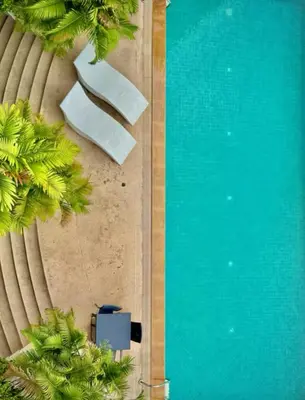 an overhead view of a swimming pool with palm trees at City Center Nana 4-Guest Suite 100m Nana BTS in Bangkok