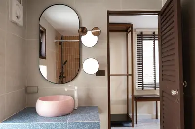 a bathroom with a pink tub sitting on a blue counter at Morya House in Bangkok