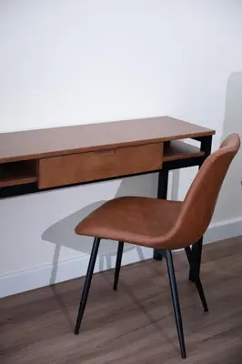 a wooden desk with a chair in front of it at Morya House in Bangkok