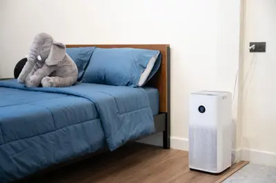 a stuffed elephant sitting on a bed next to a heater at Morya House in Bangkok