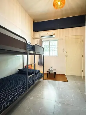 a bedroom with two bunk beds and a window at Regalohome Br in Bangkok