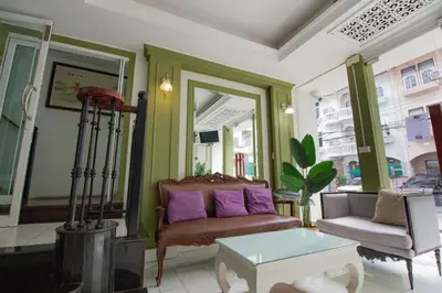 a living room with a couch and a table at Skutan-MTB Sutthisan in Bangkok
