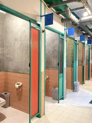 a bathroom with several toilets in a building at The Urbanists BKK Best for groups & long stay near Medpark Hospital , Queen Sirikit Convention hall , Benjakitti Park in Bangkok