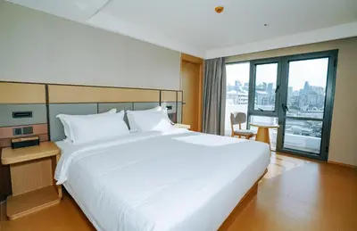 a large white bed in a hotel room with a window at \u66fc\u8c37\u4e1c\u65b9\u9152\u5e97 in Bangkok