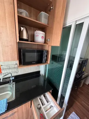 a kitchen with a sink and a microwave at Charming condo 5min walk to MRT near DMK,Chatuchak in Bangkok