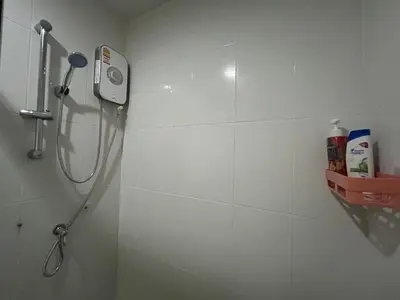 a shower in a bathroom with a shower head at Perfect 1BR at MRT Bangson by B in Bangkok