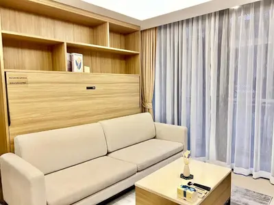 a living room with a white couch and a table at Circle 31 #1BR Bangkok in Bangkok