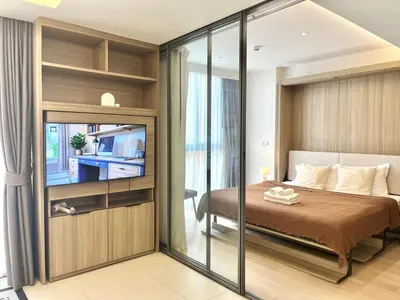 a bedroom with a bed and a sliding glass door at Circle 31 #1BR Bangkok in Bangkok