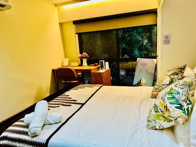 a bedroom with a bed and a table and a window at 5BR Villa with Private Pool Sukhumvit 10mins BTS in Bangkok