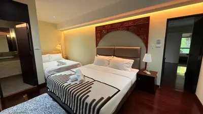 a hotel room with two beds and a large bed sidx sidx sidx at 5BR Villa with Private Pool Sukhumvit 10mins BTS in Bangkok