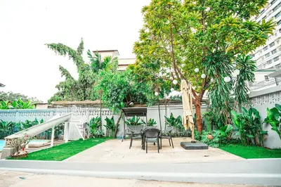 a patio with a table and chairs and a tree at 906 Bangkok City Center Single Pool Villa BTS Asok 5 Bedrooms 6 Bathrooms in Bangkok
