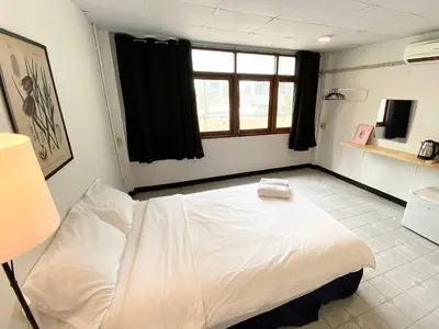 a bedroom with a white bed and a window at XX GO INN BTS Ari - BTS Ari Station in Sathani Sam Sen