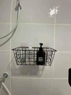 a basket on the wall of a shower in a bathroom at XX GO INN BTS Ari - BTS Ari Station in Sathani Sam Sen