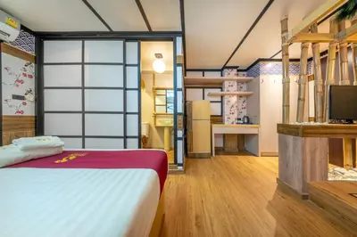 a bedroom with a bed and a tv in a room at SHIN Hotel Victory Monument in Bangkok