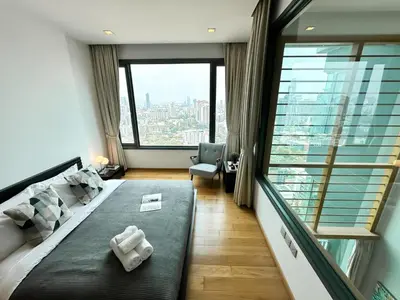 a hotel room with a bed and a large window at Expansive Loft 2BR - Ultra Fast WiFi - BTS Thonglor in Bangkok